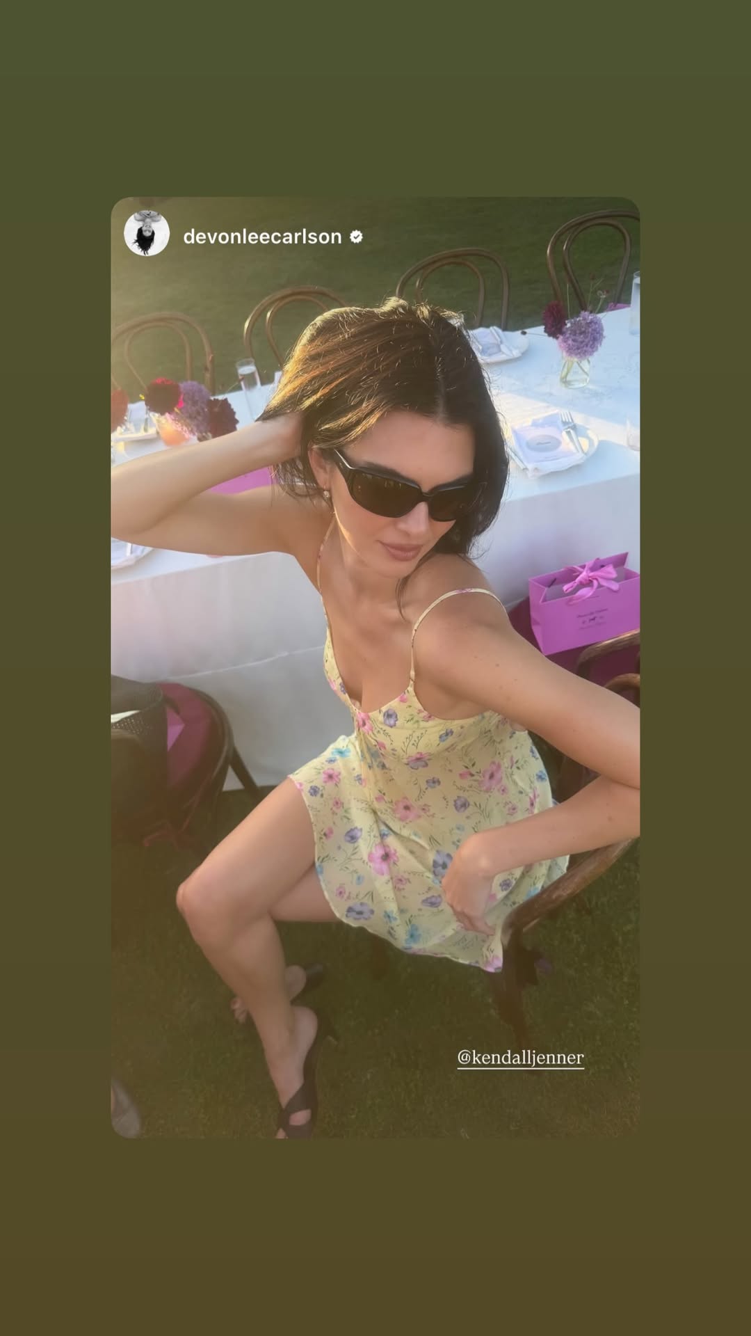 Kendall Jenner wears a butter yellow mini dress featuring pink and blue flowers from Devon Lee Carson x Frankies Bikinis