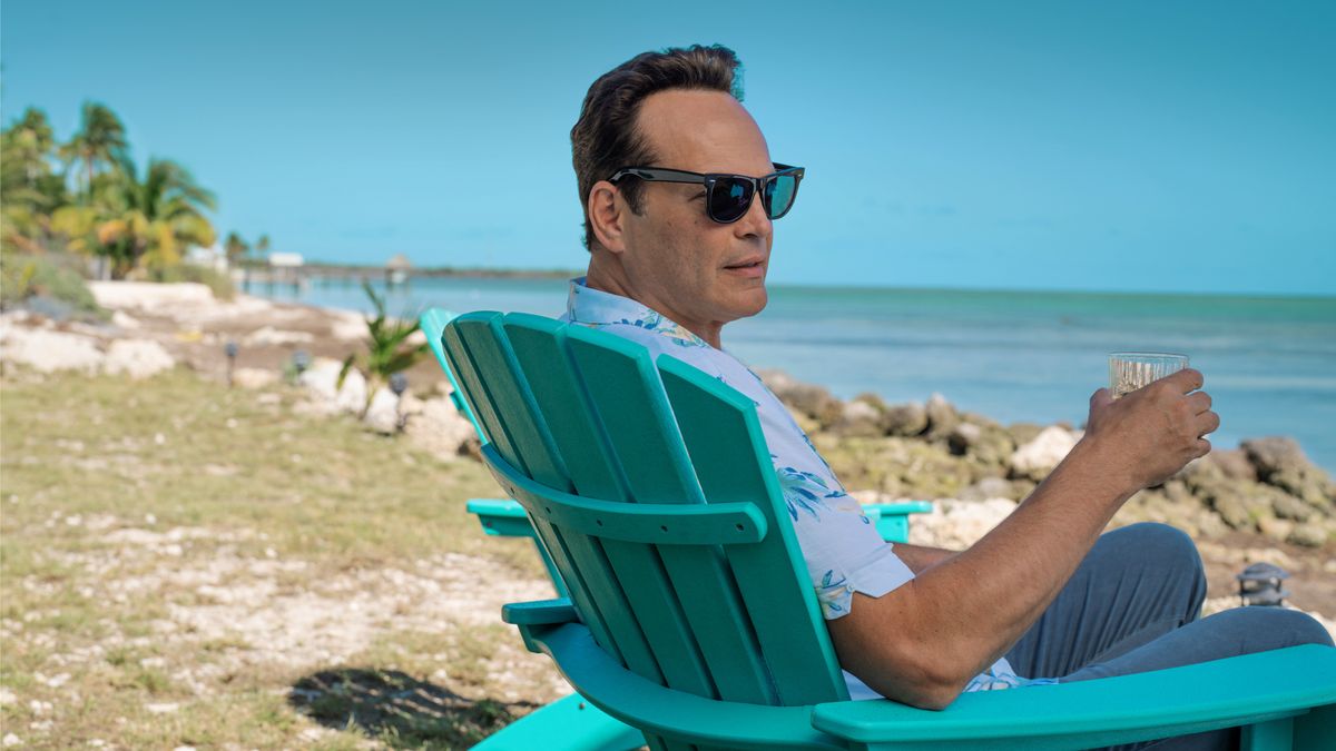 Andrew Yancy (Vince Vaughn) sits on a blue deck chair at the beach in Apple TV Plus&#039; &quot;Bad Monkey&quot;