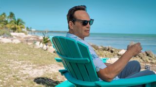 Andrew Yancy (Vince Vaughn) sits on a blue deck chair at the beach in Apple TV Plus' "Bad Monkey"