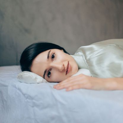 women in bed wearing silk pajamas