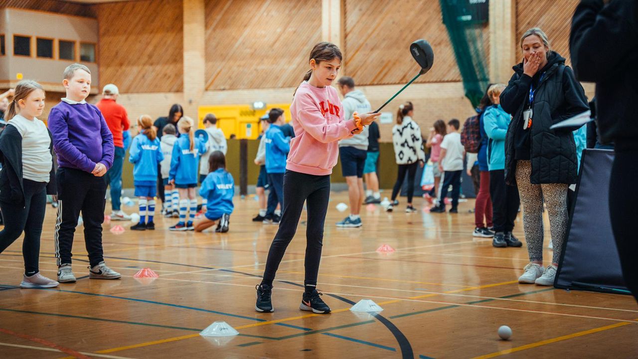 A child swinging a plastic club