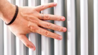 hand touching column radiator