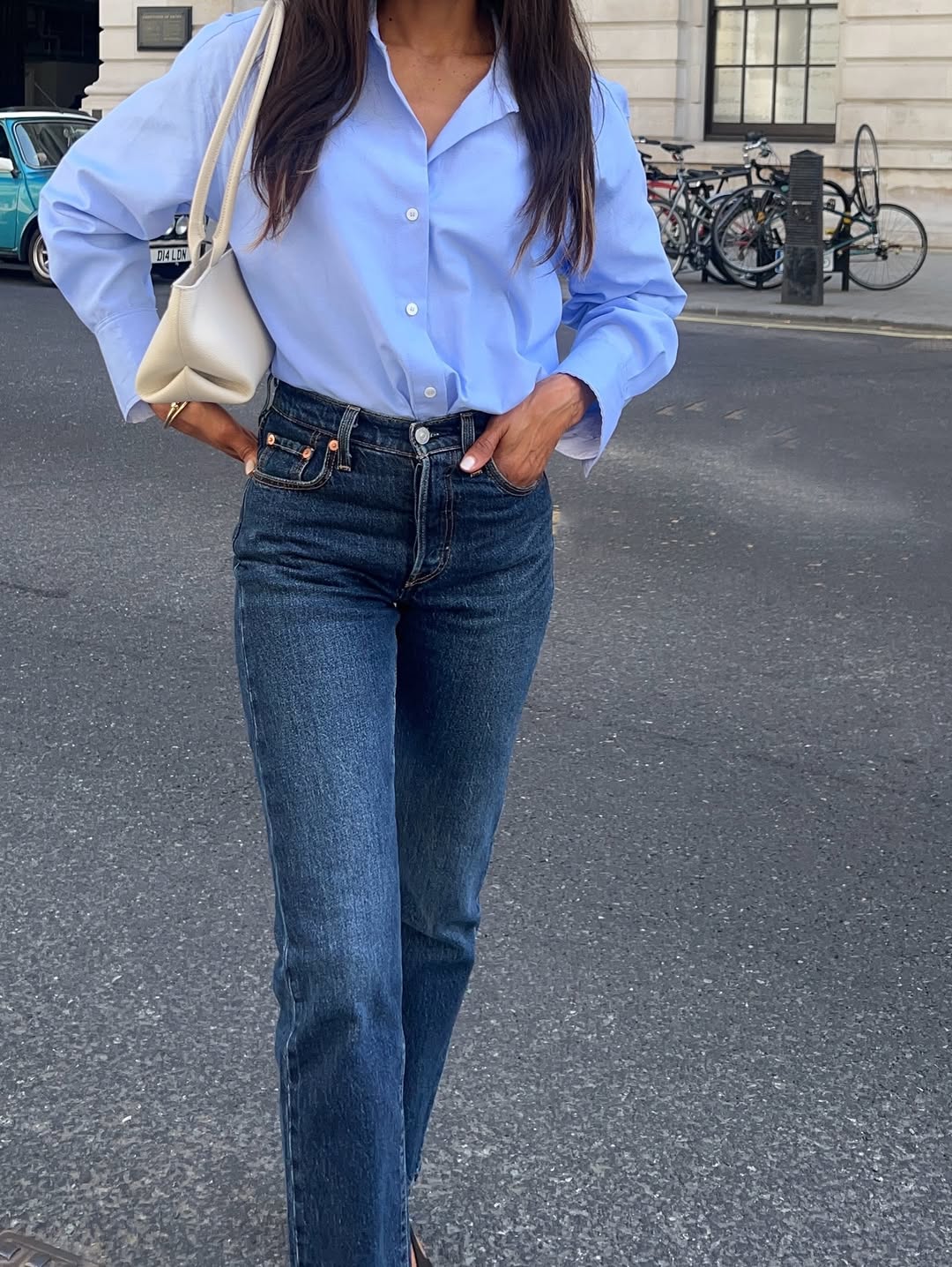 A woman wearing high-rise jeans, one of the rich-looking spring denim trends 2026.