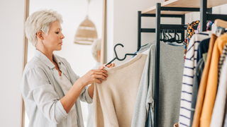 Woman choosing outfit from wardrobe