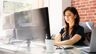 woman using multiple monitors