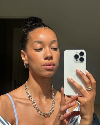 Content creator Amaka Hamelijnck with glowy skin and silver jewelry