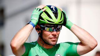 Mark Cavendish adjust his green Specialized Evade helmet at the Tour de France