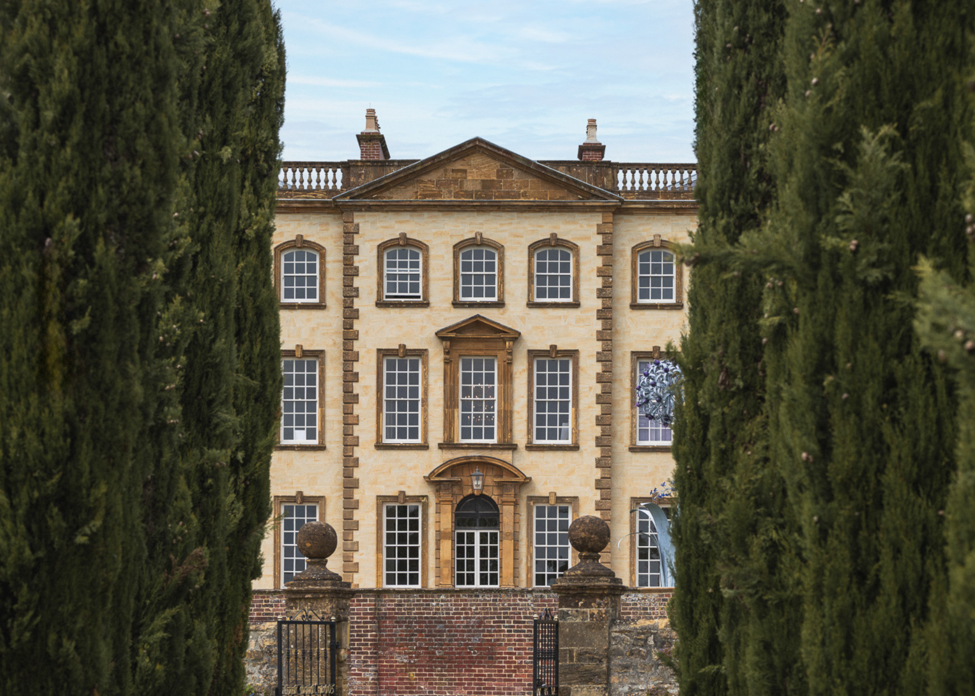 A grand georgian property framed by trees