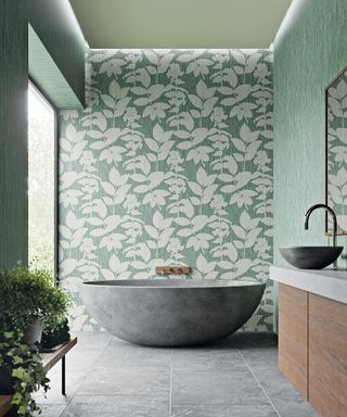 Bath ideas with botanical wallpaper and concrete bath