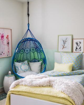 A kids bedroom with a swing suspended from the ceiling