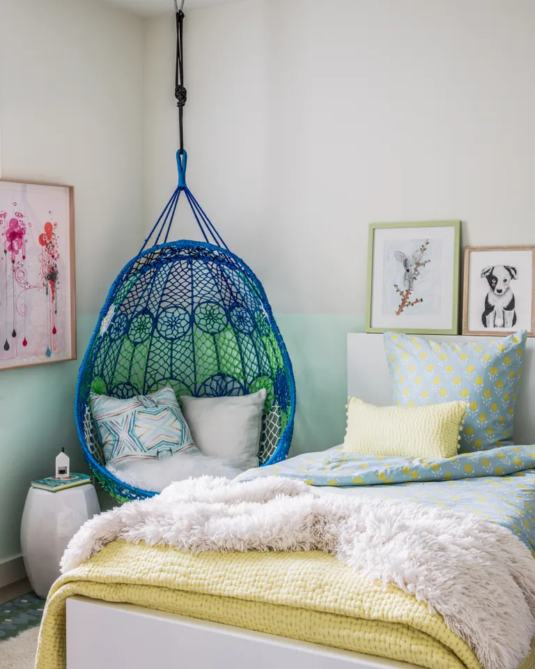 A kids bedroom with a swing suspended from the ceiling