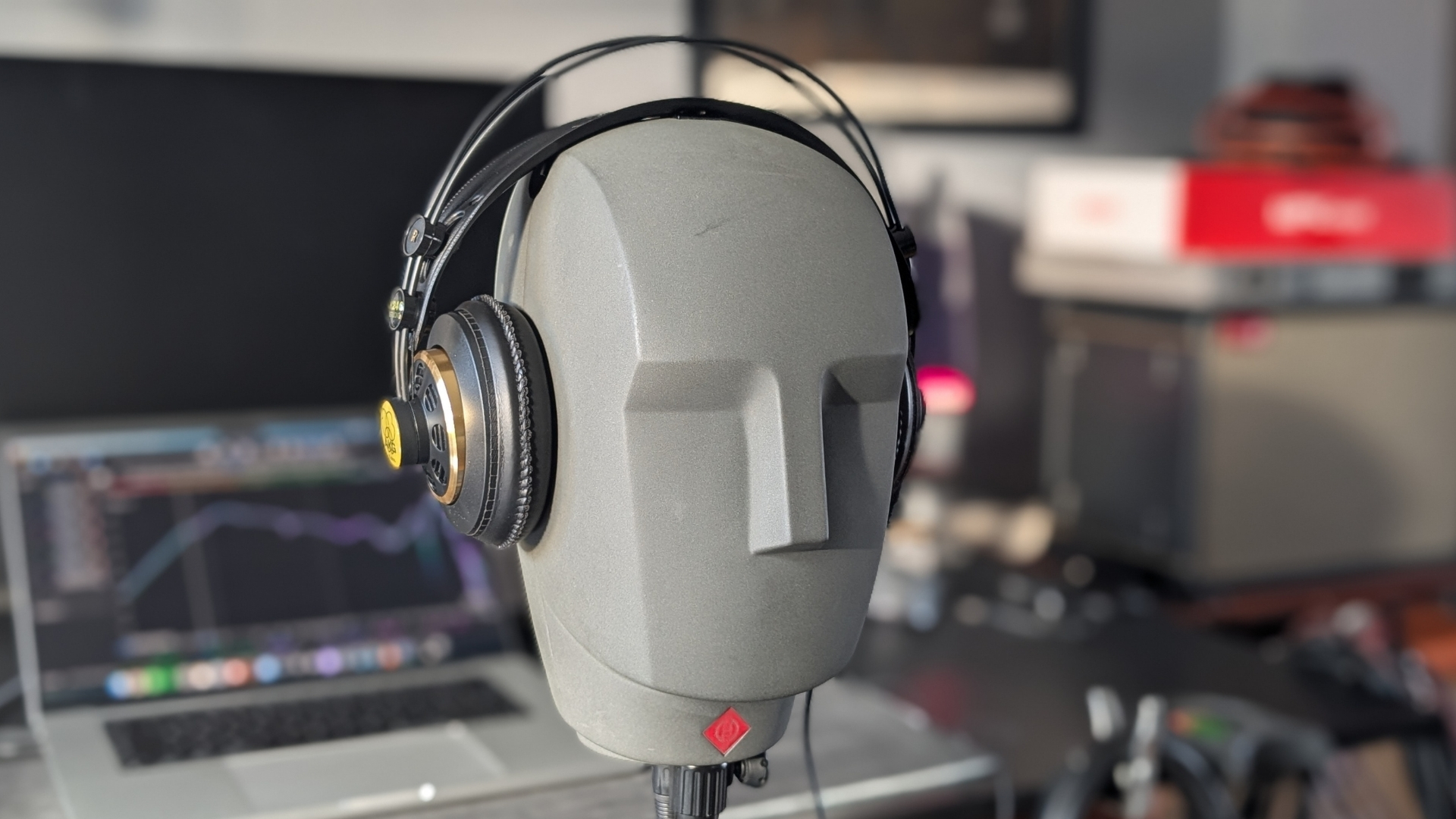 A pair of AKG K240 Studio headphones on a Neumann KU 100 dummy head
