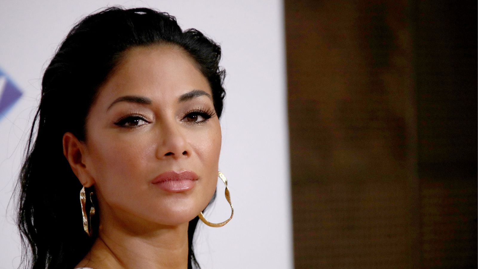 nicole scherzinger on a white and wood background