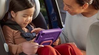 Amazon Fire HD 8 Kids 2024 lifestyle render of child in car seat using tablet