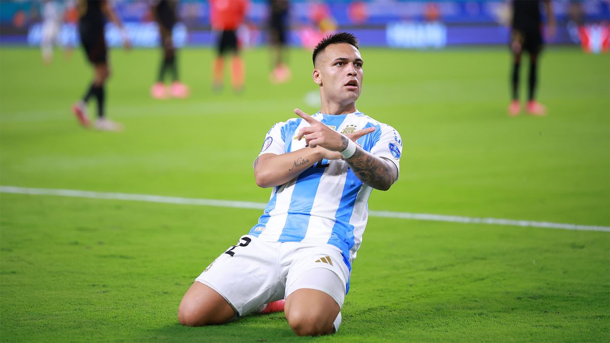 Argentina&#039;s Lautaro Martínez slides on his knees to celebrate his team&#039;s first goal against Peru at Copa America 2024.