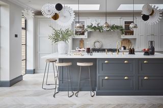 grey and white shaker kitchen with white paper decorations hanging from the ceiling