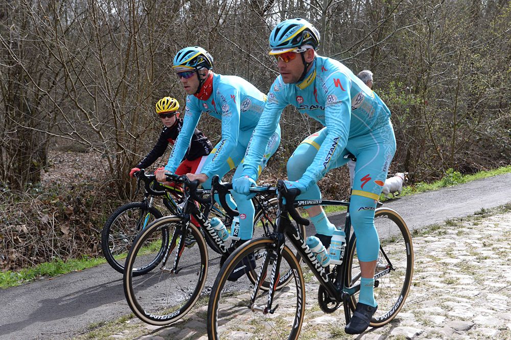 A young admirer rides alongside Lars Boom in the Arenberg forest
