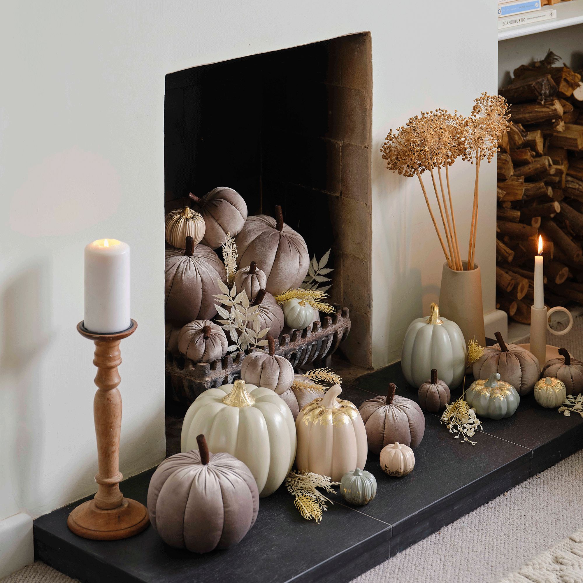 Grey plush pumpkins in fireplace