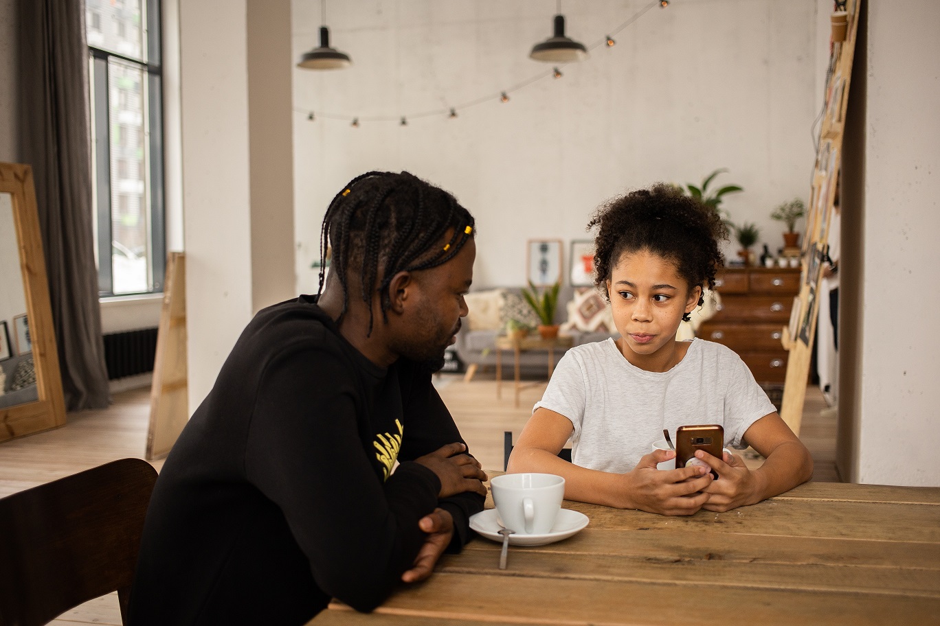 Parent and child sitting at kitchen table