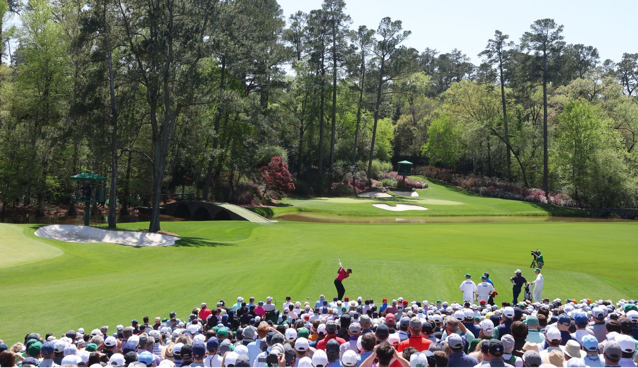 Woods hits an iron shot at 12