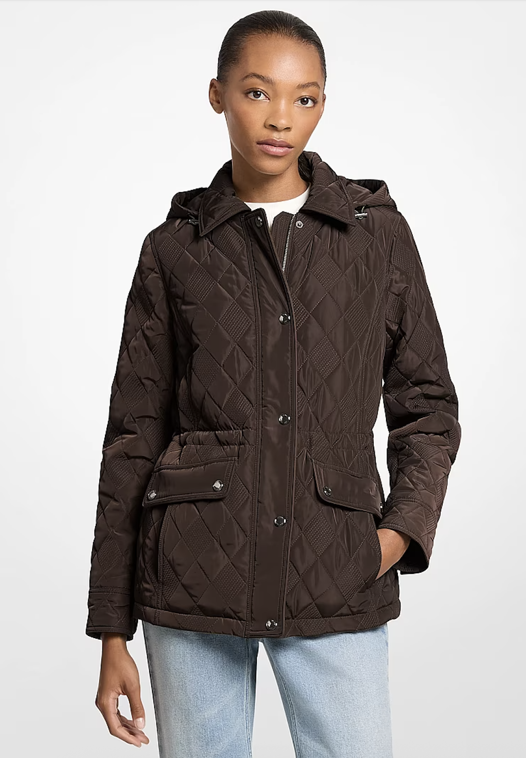a model wearing a brown quilted jacket