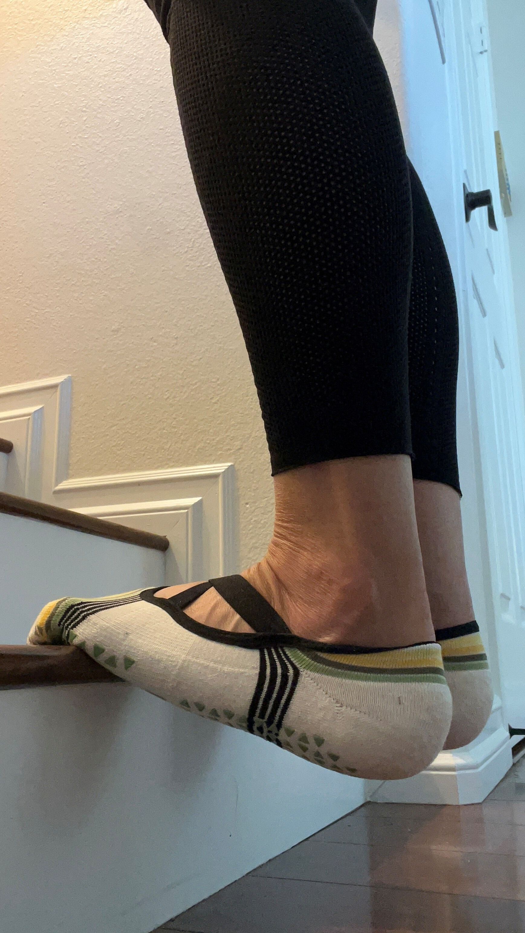 Balls of feet on a step with heels below the step