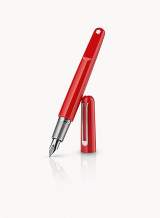 Red gloss fountain pen stood upright, silver tip, leaning against its red & silver pen lid on a white background