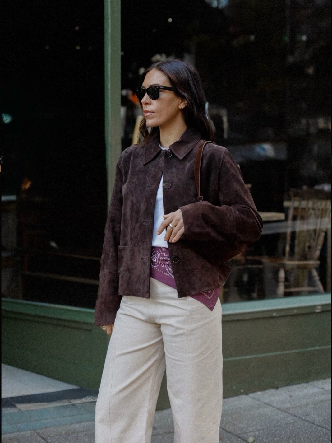 Woman wears brown suede jacket, white T-shirt, bandana and cotton trousers
