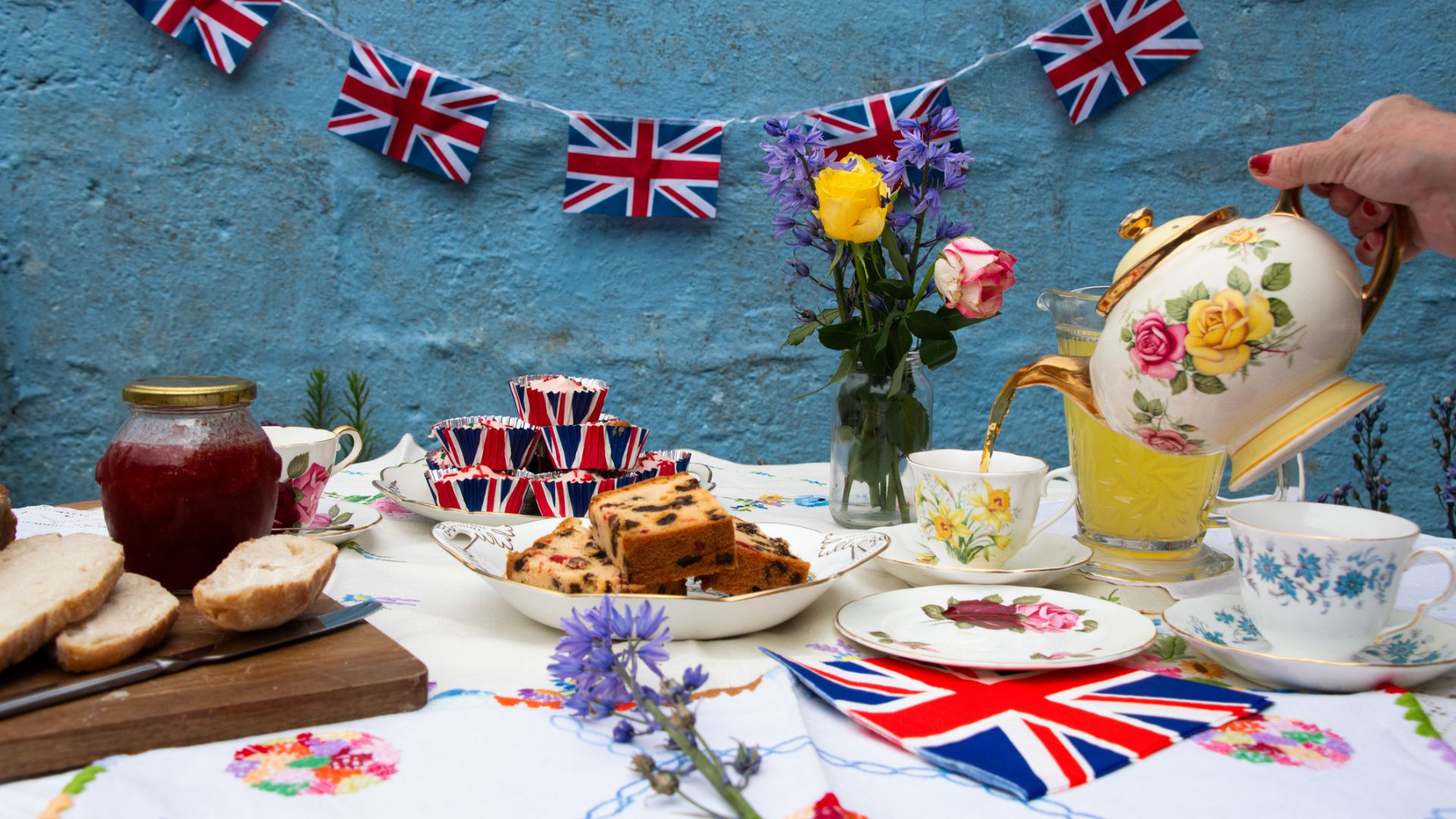 A wartime themed spread of cakes and treats with Union Jack bunting