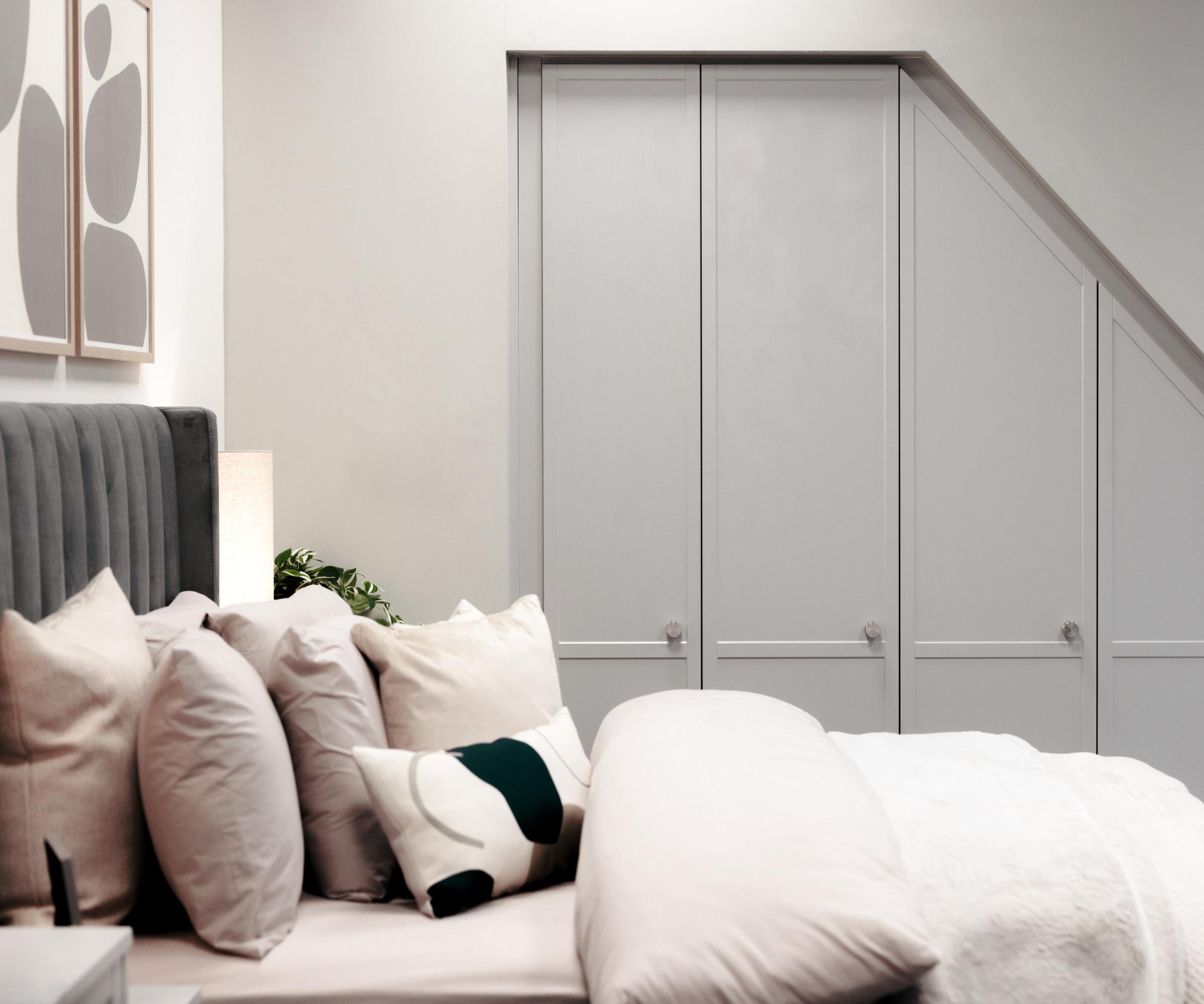 bedroom loft conversion wit built in wardrobes under sloping ceiling