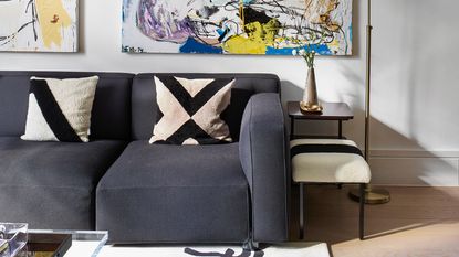 grey sofa with artwork and pillows