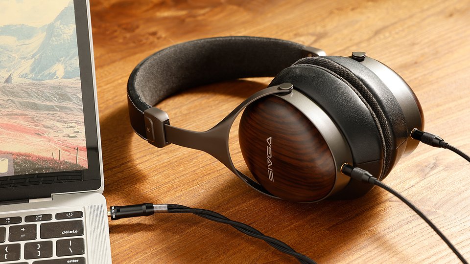 The SIVGA SV021 Pro headphones are shown plugged into a laptop with a braided cable, emphasizing the dual-entry 3.5mm connections on the wooden earcups.