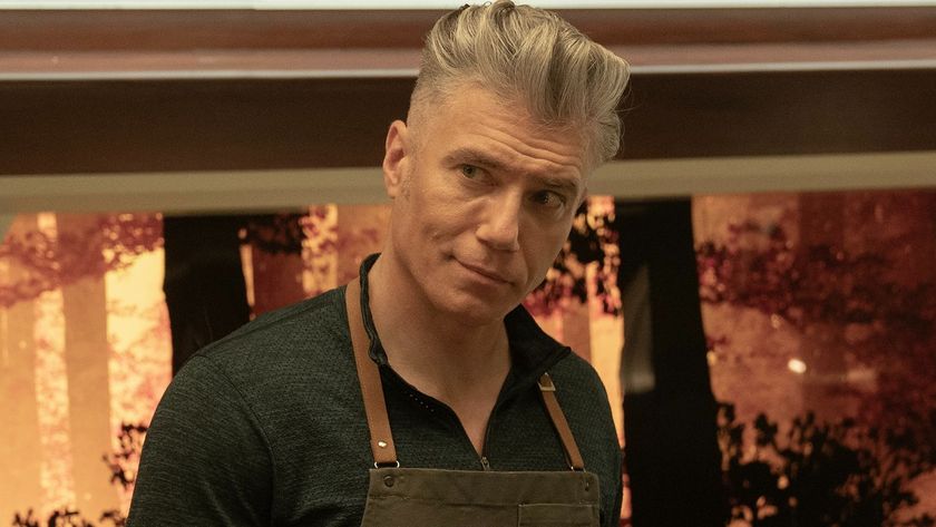 Pike working on a meal with an apron on. 