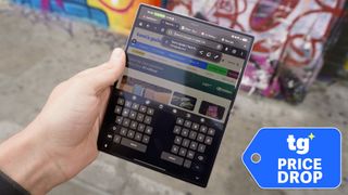 Galaxy Z Fold 8 held in front of a wall with graffiti