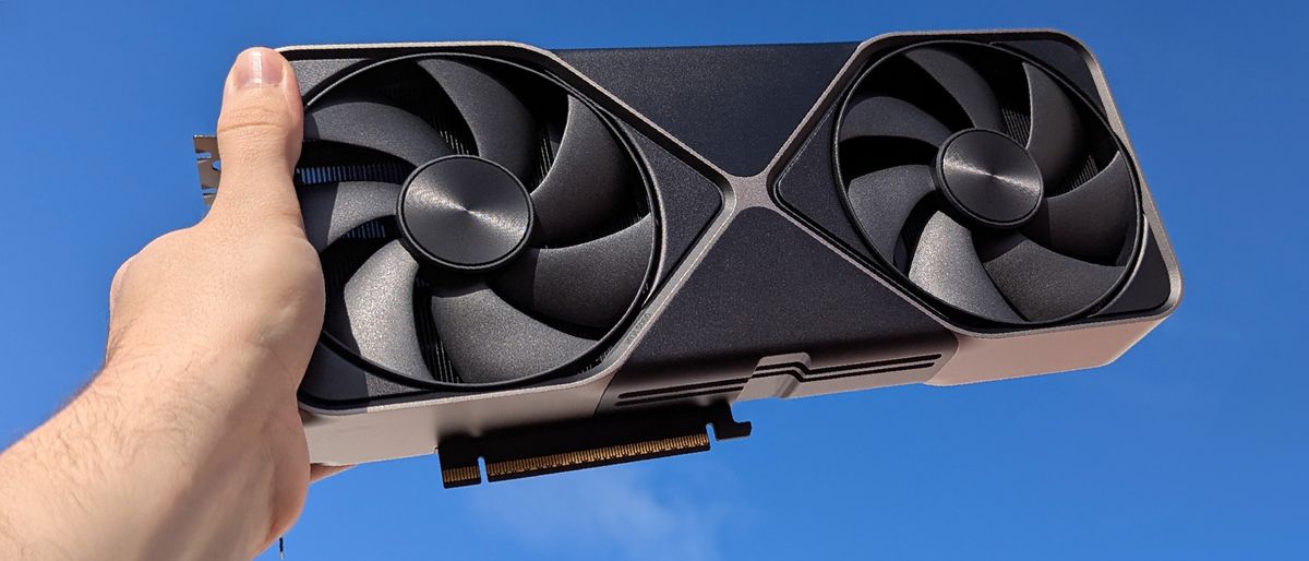 NVIDIA GeForce RTX 5080 Founders Edition held to a blue sky