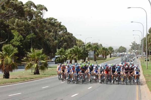 The peloton ease off with a break up the road