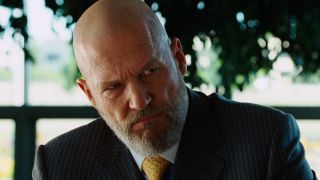 Jeff Bridges' Obadiah Stane looking at Tony Stark give press conference