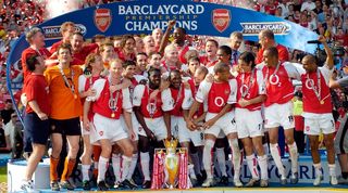 Arsenal players celebrate with the Premier League trophy in May 2004 after winning the title without losing a single game in 2003/04.