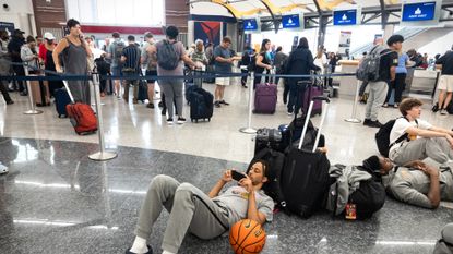 Delta customers wait in line for new flights after tech outage canceled thousands of flights