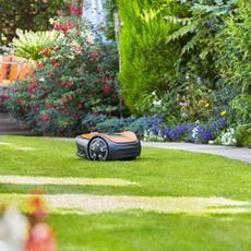 Flymo robot lawn mower on lawn in promotional image 