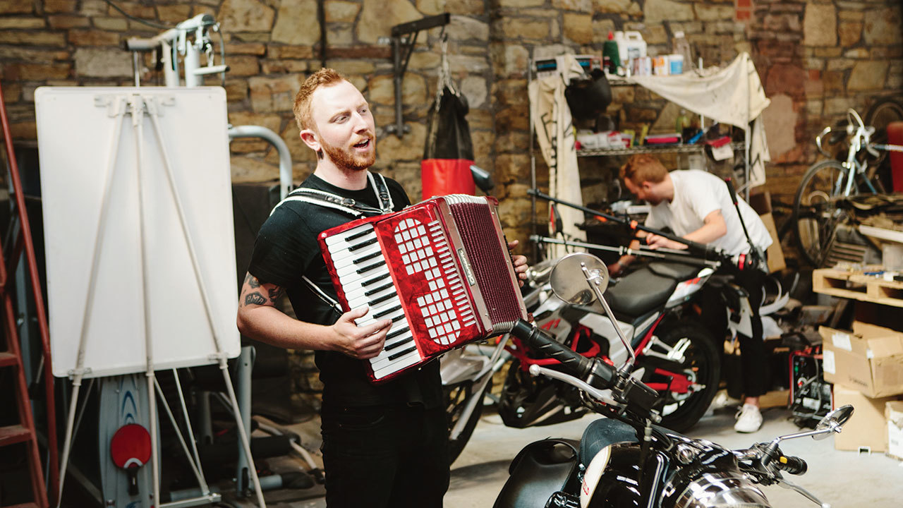 A photograph of While She Sleeps and an accordion