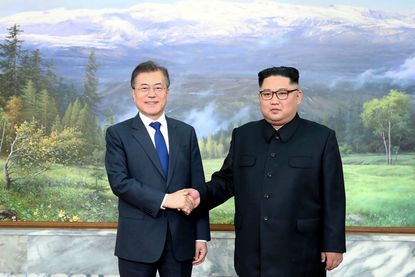 Moon Jae-in and Kim Jong Un.