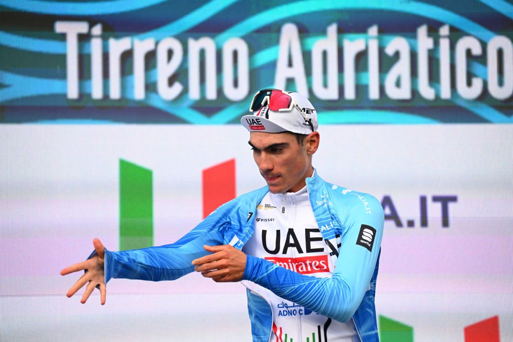 FOLLONICA ITALY MARCH 05 Juan Ayuso of Spain and UAE Emirates Team celebrates at podium as Blue Leader Jersey winner during the 59th TirrenoAdriatico 2024 Stage 2 a 198km stage from Camaiore to Follonica UCIWT on March 05 2024 in Follonica Italy Photo by Tim de WaeleGetty Images