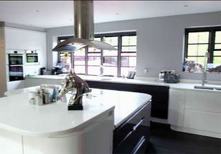 kitchen area with white wall and white countertop