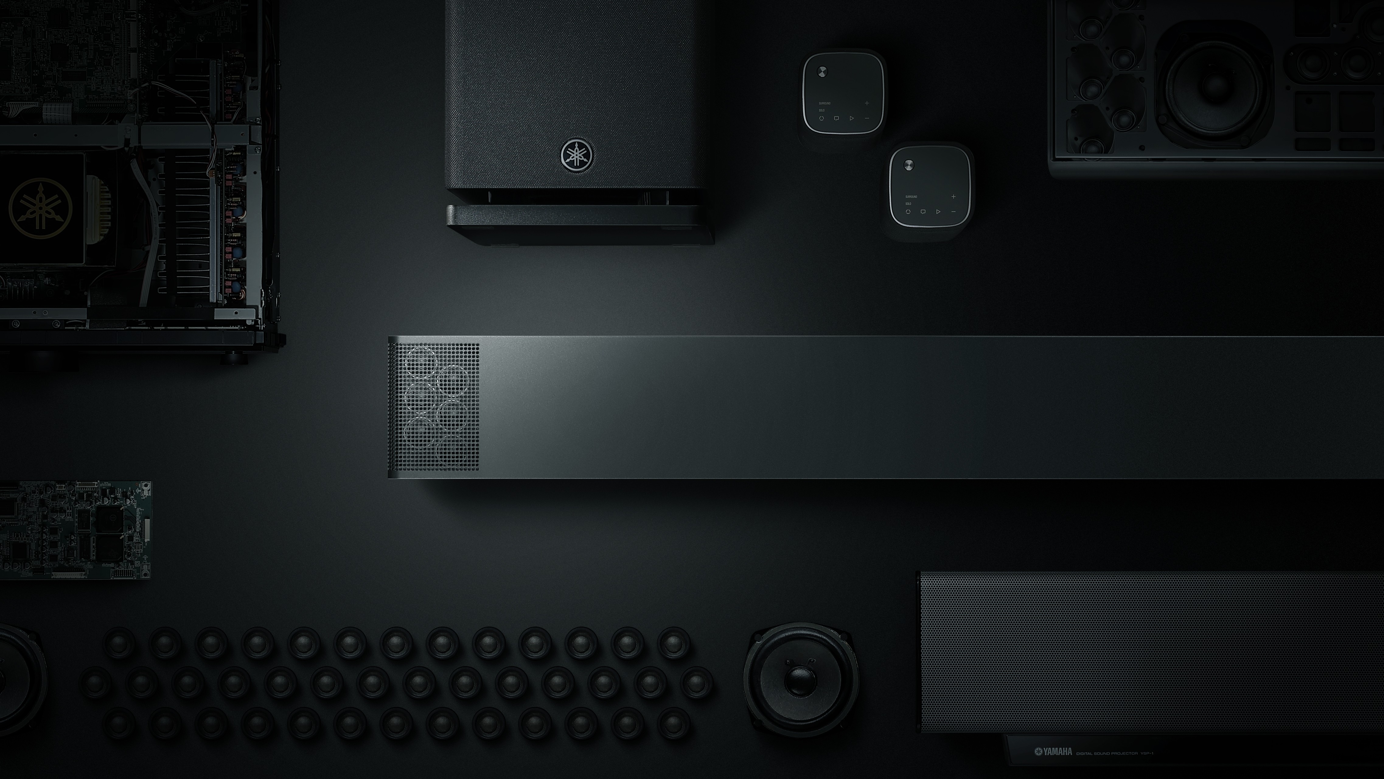 Components of the Yamaha True X 90A system on a black background