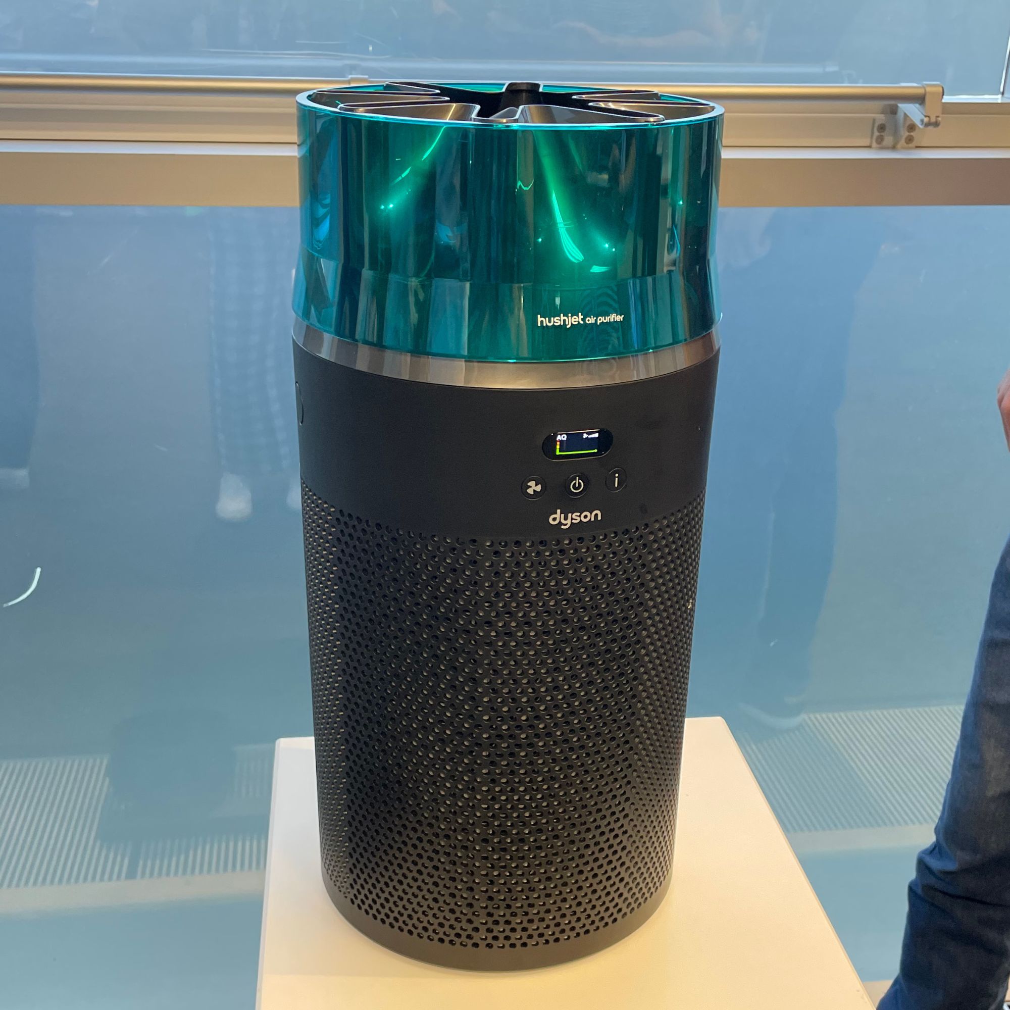 Dyson HushJet Air Purifier standing on a white plinth in front of window
