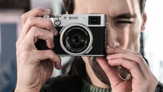 Gareth Bevan holding Fujifilm X100VI compact camera 