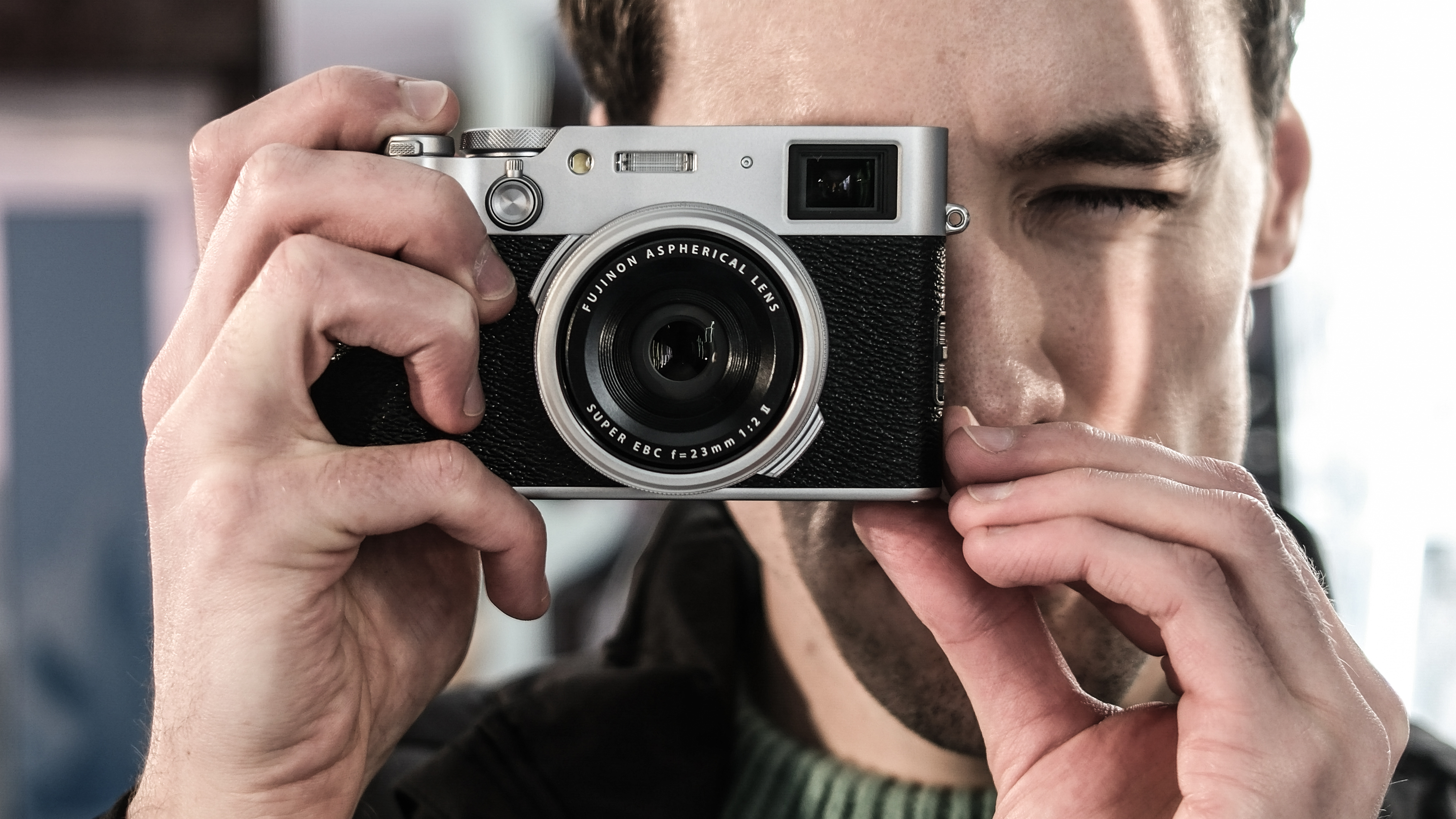 Gareth Bevan holding Fujifilm X100VI compact camera 