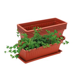 Two rectangular window boxes, one with a plant in it