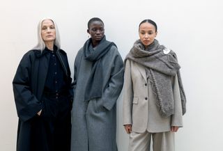Three women backstage at Skall Studio in a guide to the fall 2024 trends from Copenhagen Fashion Week